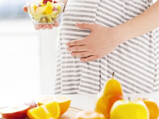Pregnant women eating fruit salad