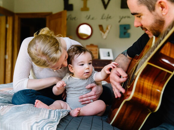 Baby listening to daddy play guitar