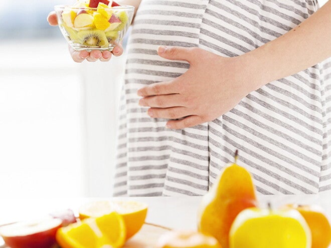 Pregnant women eating fruit salad Pregnant women eating fruit salad