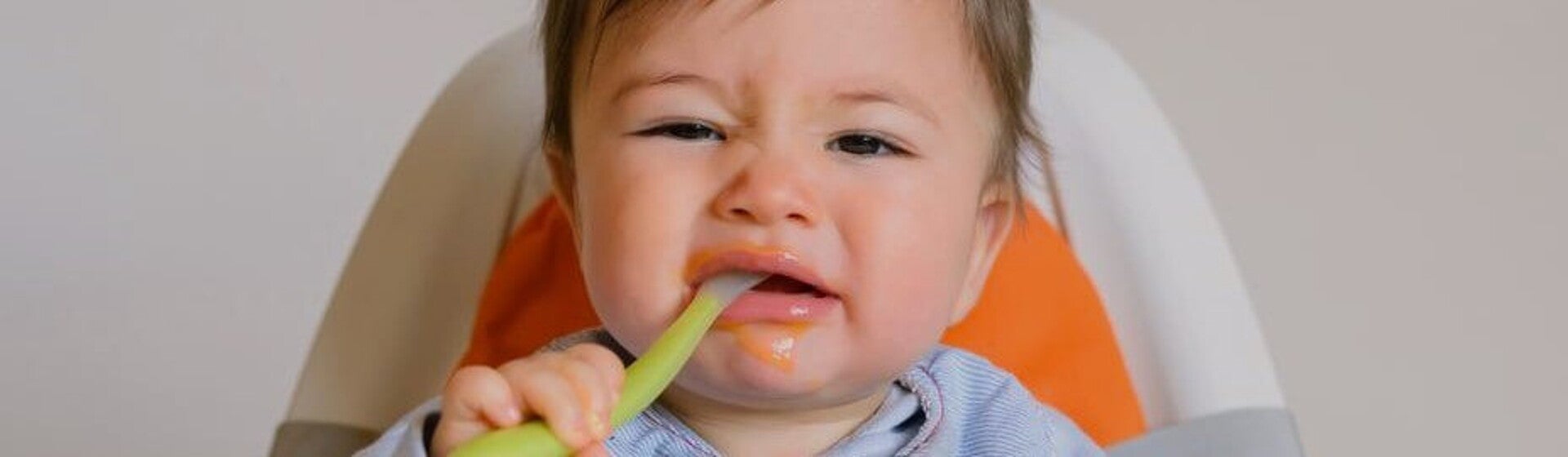 Baby with spoon in mouth looking unimpressed Baby with spoon in mouth looking unimpressed