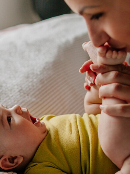 Mother kisses baby